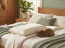 Kids Pillow — layered on a made bed with sage bedding and a bunny