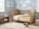 Latex Mattress Topper — the cot-size topper layered on a cot mattress in a nursery